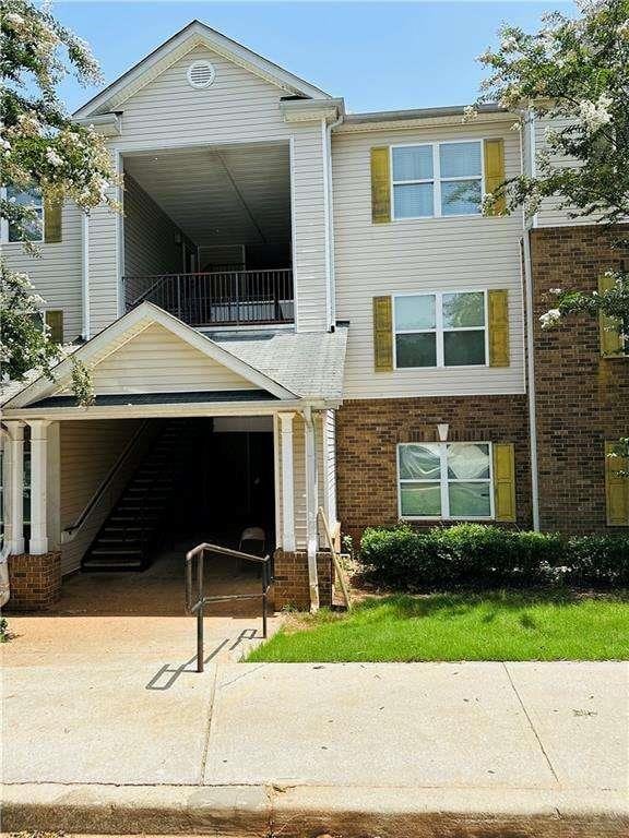 view of front of house with a balcony and brick siding