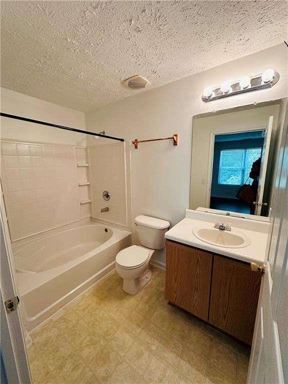 bathroom featuring toilet, vanity, shower / tub combination, tile patterned floors, and a textured ceiling