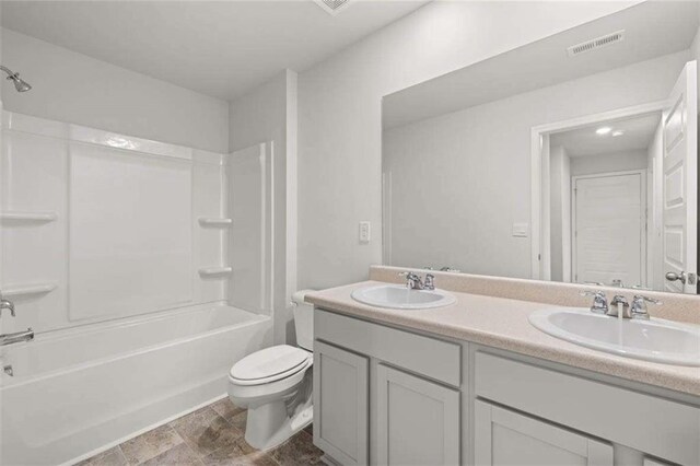 full bathroom with bathing tub / shower combination, vanity, and toilet