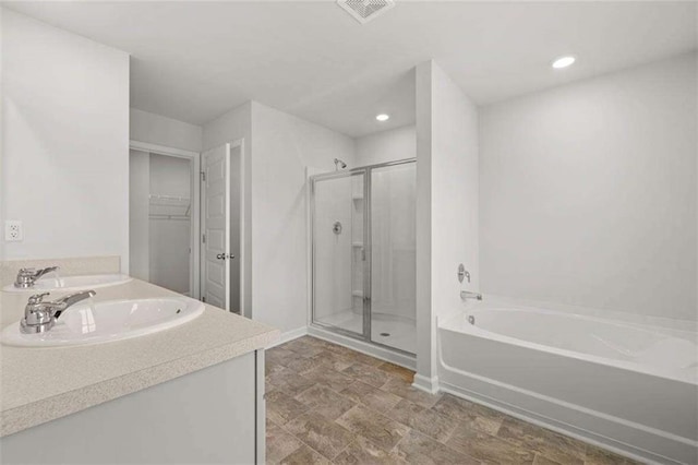 bathroom with vanity and separate shower and tub