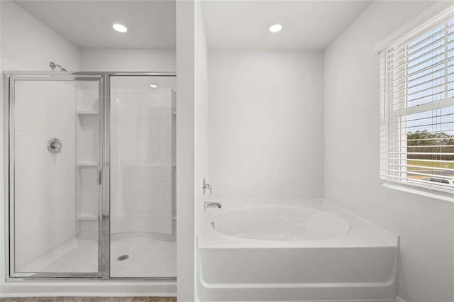 bathroom with plus walk in shower and a healthy amount of sunlight