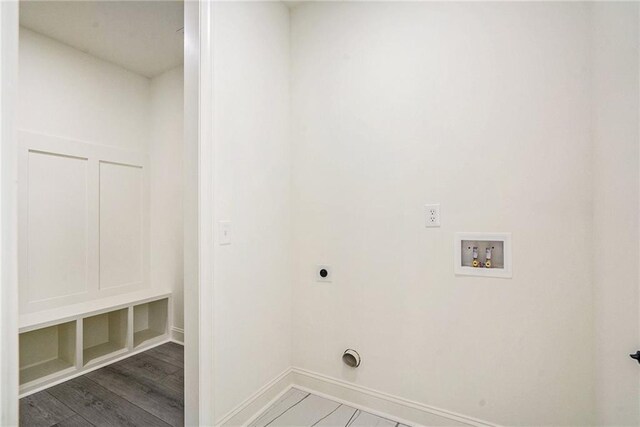 laundry area with hookup for an electric dryer, hookup for a washing machine, and dark wood-type flooring