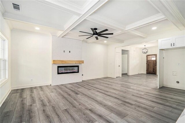 unfurnished living room featuring beam ceiling, a fireplace, ceiling fan, and light hardwood / wood-style flooring