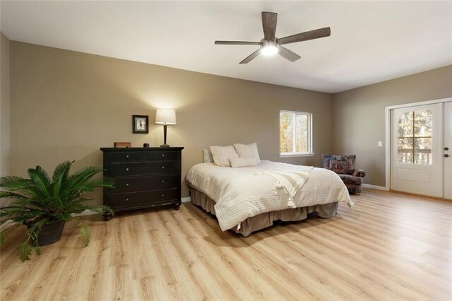 bedroom featuring access to outside, light hardwood / wood-style floors, and ceiling fan