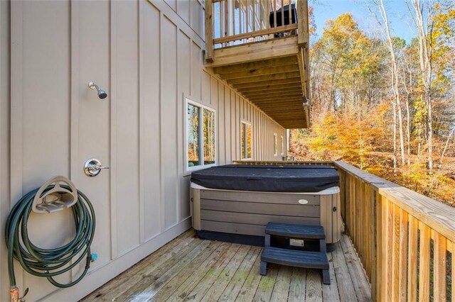 wooden deck with a hot tub