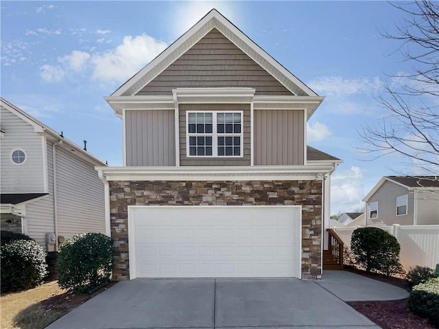 view of front of property with a garage, stone siding, board and batten siding, and concrete driveway