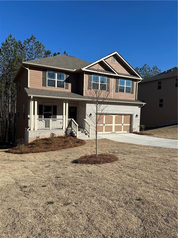 view of front of property with covered porch and a garage