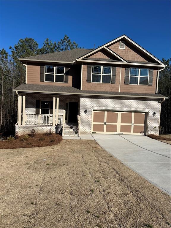 view of front of property with a porch and a garage