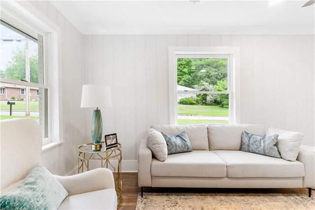 living area with a healthy amount of sunlight and wood finished floors