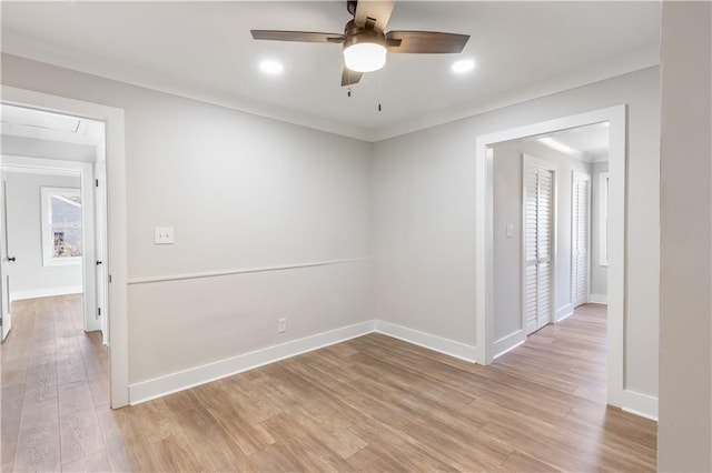 unfurnished room featuring baseboards, a ceiling fan, light wood-style floors, and ornamental molding