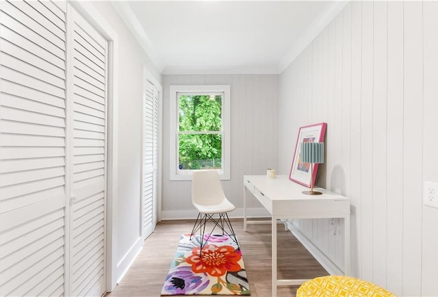 home office with light wood-type flooring, baseboards, and crown molding