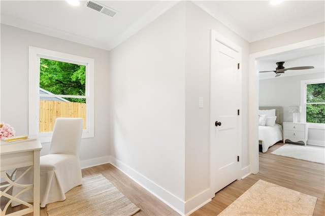 interior space featuring light wood-type flooring, baseboards, and visible vents