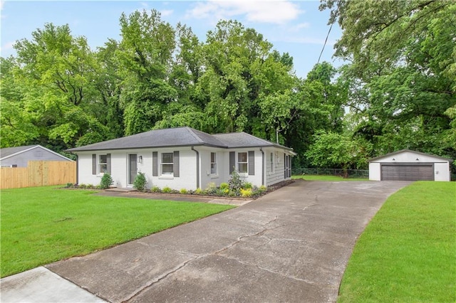 single story home featuring fence, a detached garage, an outdoor structure, and a front yard