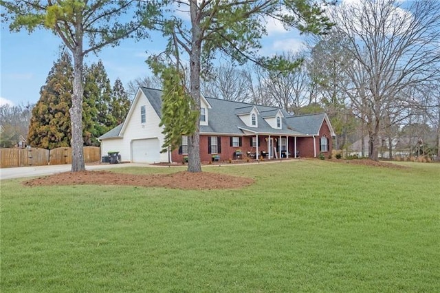 cape cod-style house featuring a garage and a front lawn