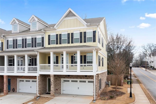 view of front of house featuring brick siding, board and batten siding, driveway, and a garage