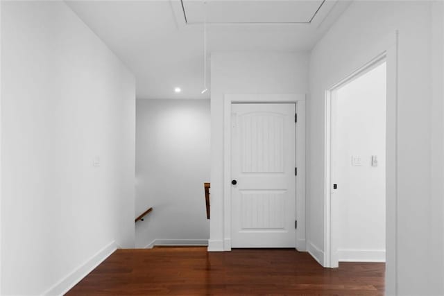 hallway with attic access, an upstairs landing, wood finished floors, and baseboards