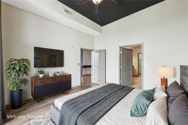 3400 Malone Dr Unit 303, Atlanta, GA 30341 - bedroom with a towering ceiling, wood finished floors, baseboards, and a ceiling fan