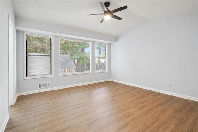 spare room featuring ceiling fan, vaulted ceiling, and light wood-type flooring