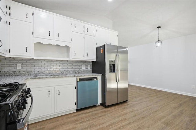 kitchen with backsplash, decorative light fixtures, lofted ceiling, and stainless steel appliances