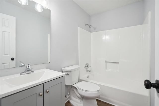 full bathroom featuring vanity, wood-type flooring,  shower combination, and toilet