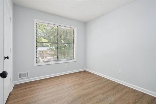 spare room featuring light hardwood / wood-style flooring