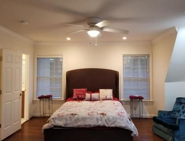 bedroom with dark wood-type flooring, crown molding, and ceiling fan