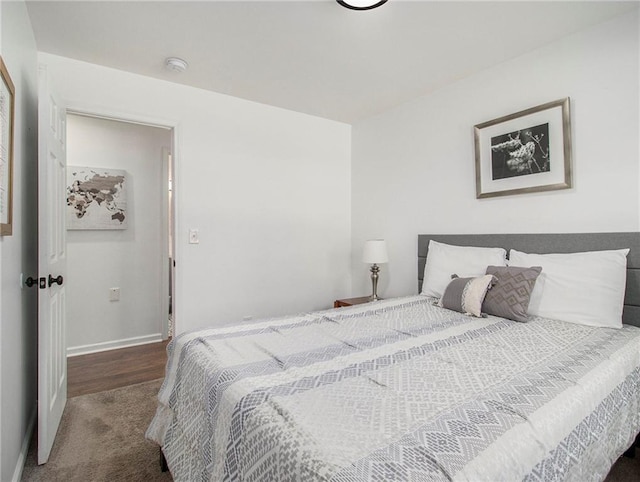 bedroom with dark colored carpet