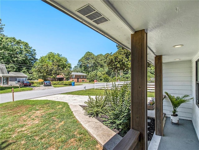 view of yard featuring covered porch