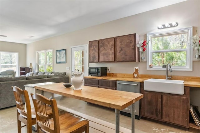 kitchen with dark brown cabinets, stainless steel appliances, and sink