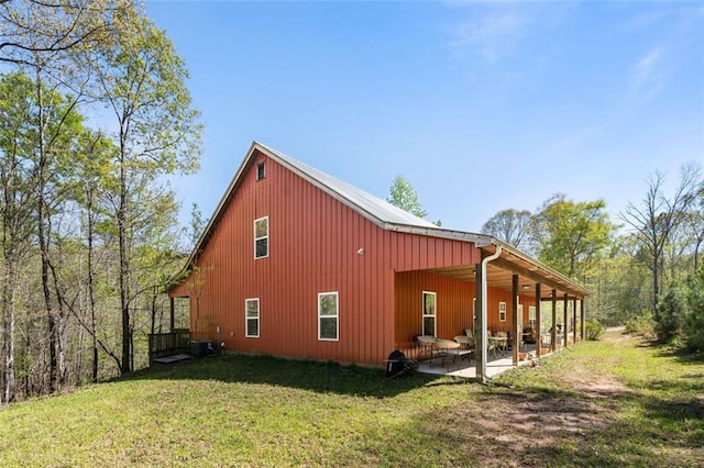 rear view of house featuring a yard