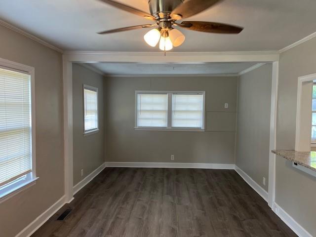 633 Tom Read Dr, Marietta, GA 30062 - unfurnished room with crown molding, dark wood finished floors, healthy amount of natural light, baseboards, and ceiling fan