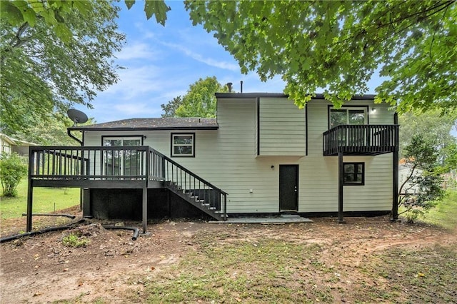 back of property featuring a deck