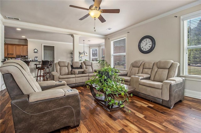 living area featuring visible vents, dark wood-type flooring, and ceiling fan