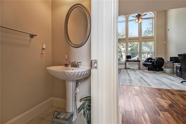 bathroom featuring wood finished floors and baseboards