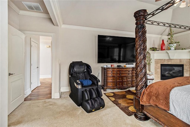 carpeted bedroom featuring visible vents, baseboards, ornamental molding, and a fireplace