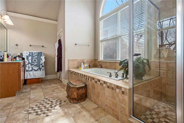 full bath with ornamental molding, a shower stall, baseboards, a bath, and vanity