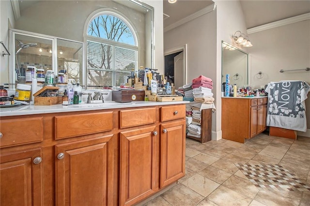 kitchen featuring a sink, brown cabinets, ornamental molding, and light countertops