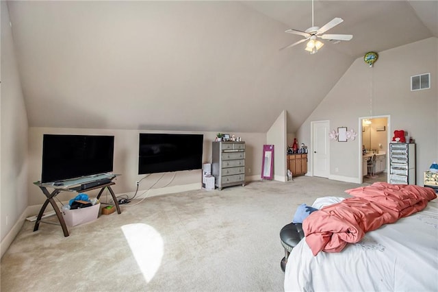 carpeted bedroom with visible vents, lofted ceiling, baseboards, and ensuite bath