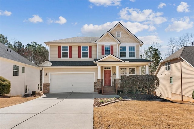 craftsman house featuring a porch, stone siding, driveway, and an attached garage