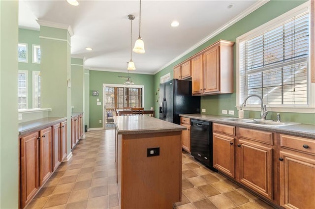 kitchen with a kitchen island, a sink, hanging light fixtures, black appliances, and ornamental molding