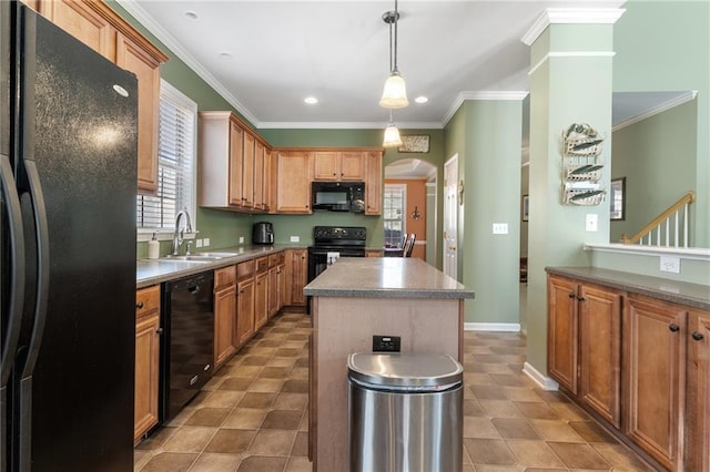 kitchen featuring a center island, crown molding, arched walkways, black appliances, and a sink