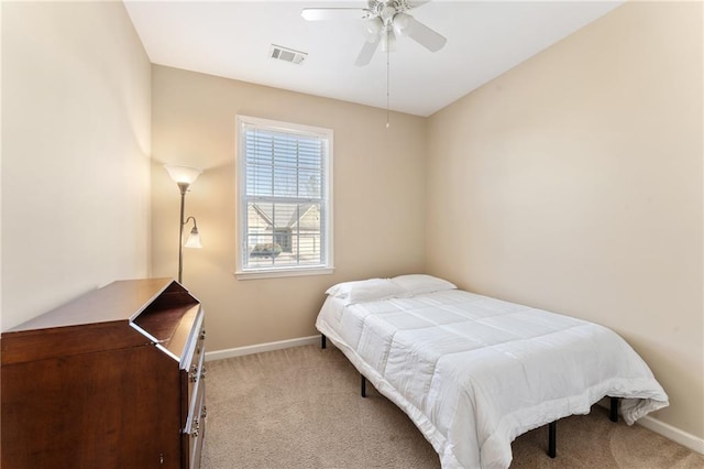 carpeted bedroom featuring baseboards, visible vents, and ceiling fan