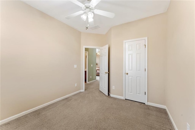 unfurnished bedroom with a ceiling fan, light colored carpet, and baseboards