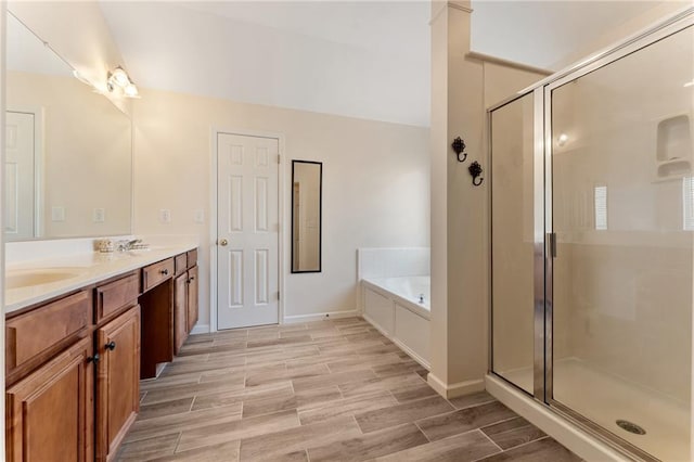 full bath featuring wood finish floors, a garden tub, and a shower stall