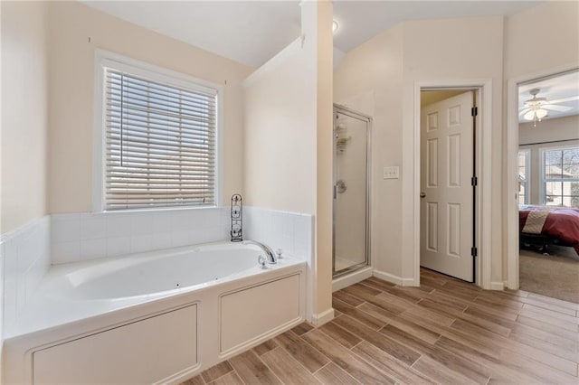 ensuite bathroom featuring a bath, a stall shower, ensuite bathroom, and wood tiled floor