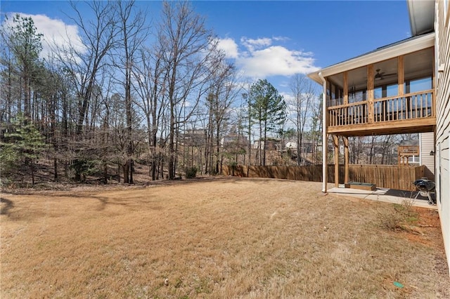 view of yard featuring a ceiling fan and fence