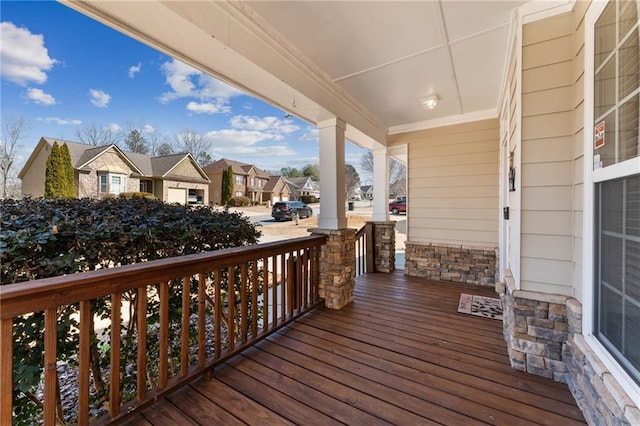 wooden deck featuring a porch and a residential view