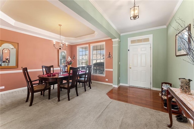 dining space featuring crown molding, baseboards, carpet, and a tray ceiling