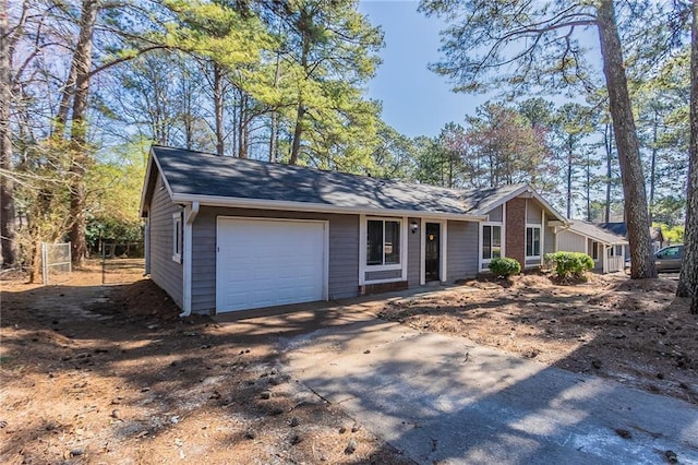 view of front of property with concrete driveway and an attached garage