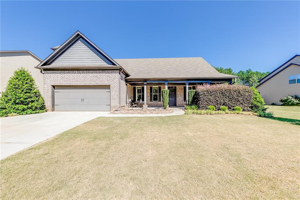 view of front of property with a garage and a front yard